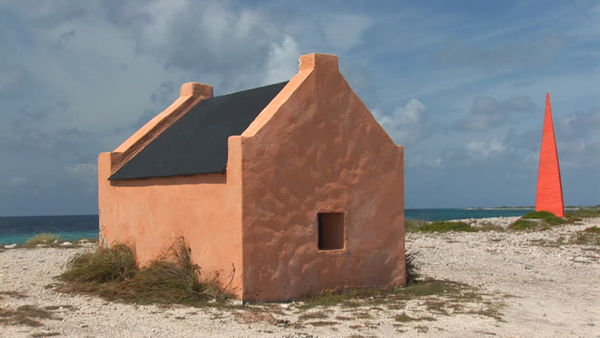 Red Slave Hut and beacon wit pan to left. Shot on Bonaire, Netherlands Antilles.