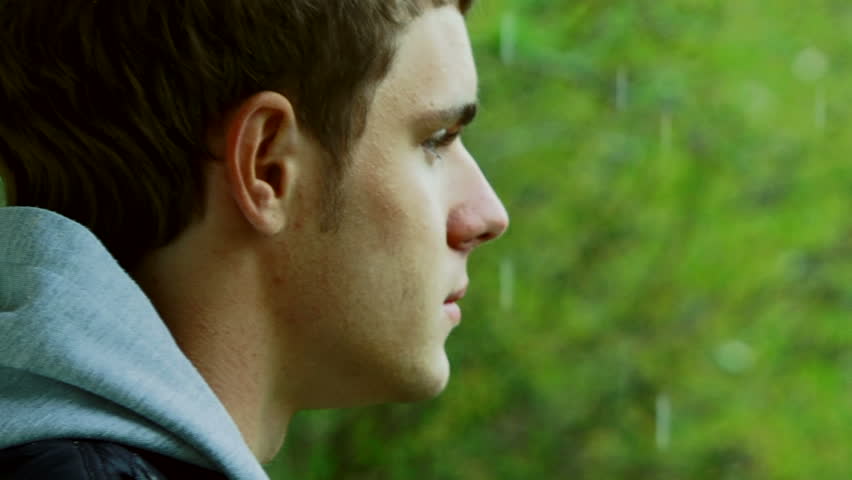A young man with a camera photographing beautiful green scenery. Motion zoom.