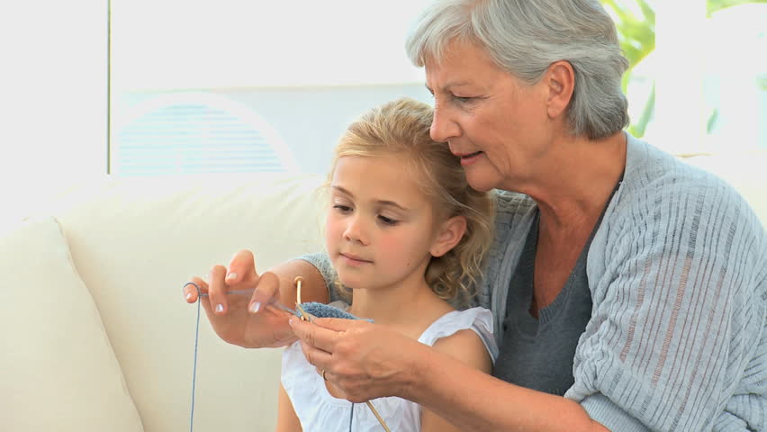 Grandmother with her grand daughter knitting