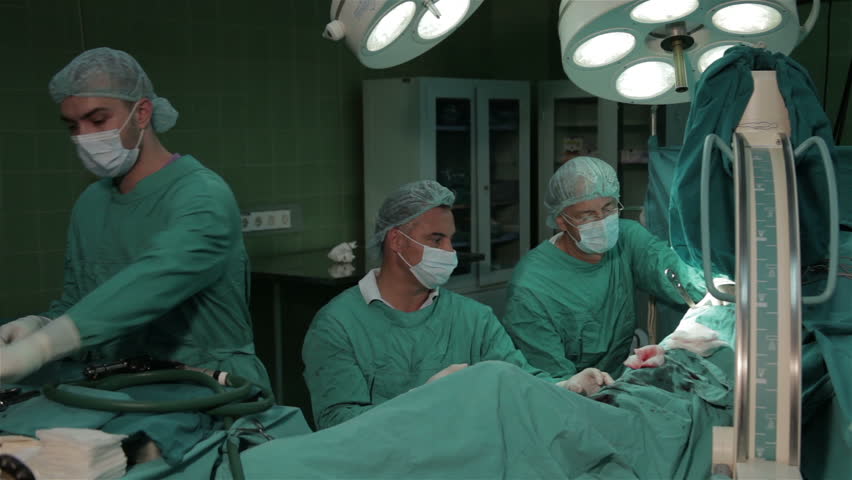 Surgeons Team Performing Surgical Operation Cesarean Section In Operating Room Gynecologists