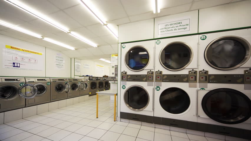 public laundry room with large washing machines