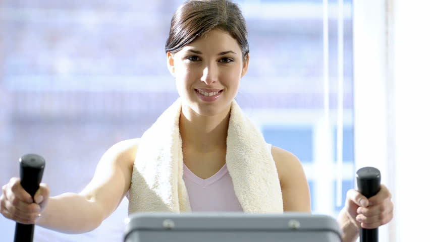 Beautiful young woman exercising on stepper; HD Photo JPEG