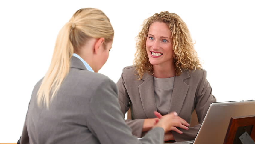 Curly blond haired woman having a meeting with an other businesswoman