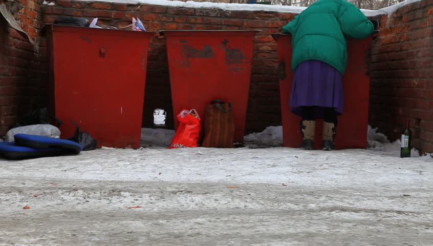Woman looking in a trash food