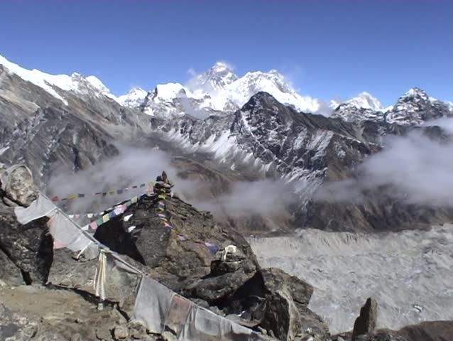 Buddhist prayer flags on Gokyo Ri in Nepal, with Mount Everest towering above in the distance