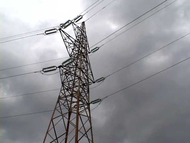 power pylon tower over the cloudy sky in time lapse (tripod)