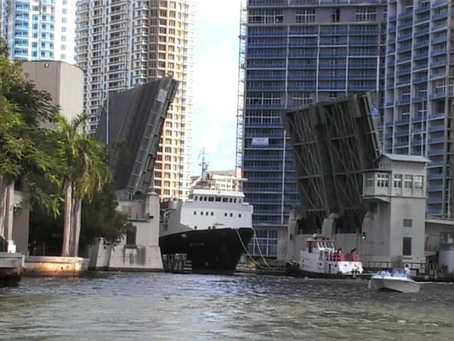 container ship passing along Miami River through open draw bridge 
