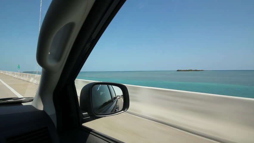 Driving. Florida Keys. Driving on a causeway in the Florida Keys. Blue and turquoise ocean with island. 