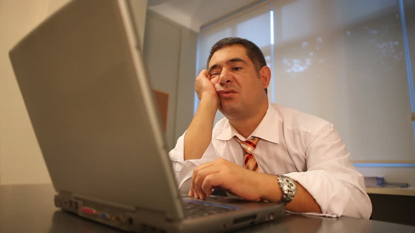Sleepy businessman using laptop in office - Work - Waiting - Tired - Technology - Business