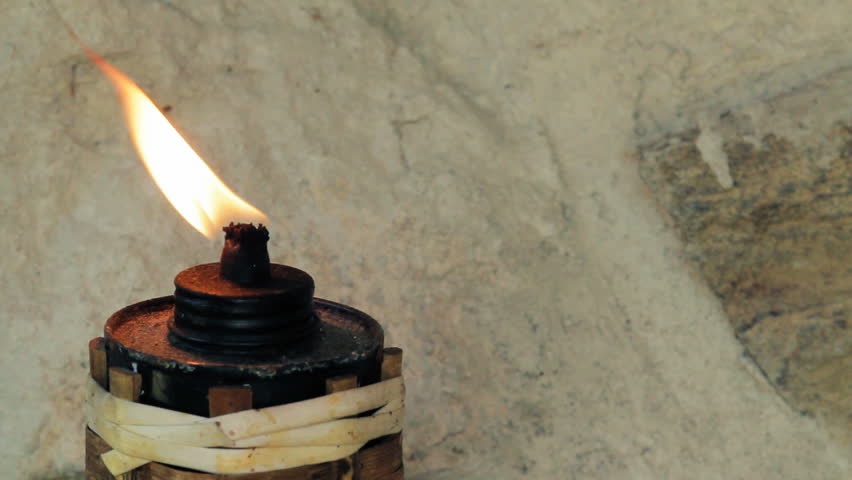 closeup of Burning garden torch on the wall