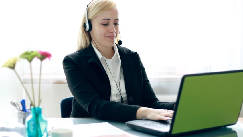 Attractive businesswoman, helpdesk consultant talking on headset