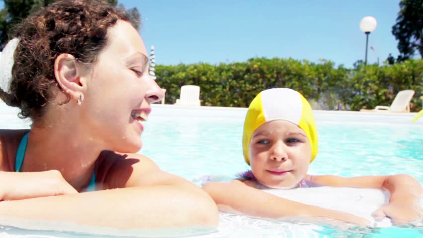 Mother and daughter are in the pool