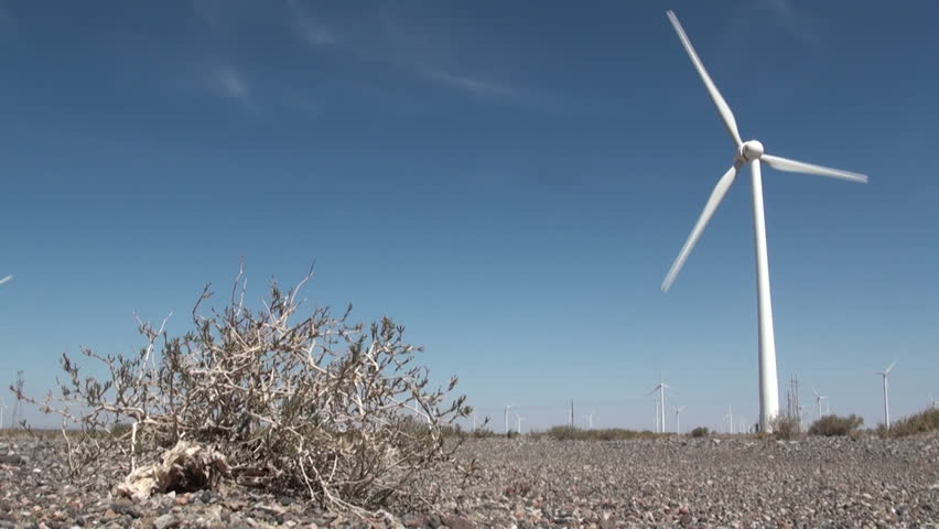 A stark contrast, windmill in a dry desert.