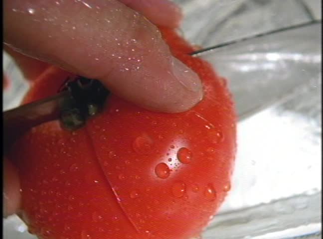 "Tomato being sliced"