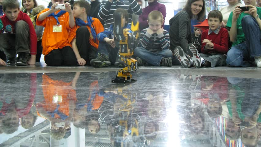 MOSCOW - APRIL 9: (Timelapse view) Children watch robot dancing at Robofest 2011 April 9, 2011 in Moscow, Russia. Robofest is one of Europes largest public events in engineering for young people as well as an event held internationally. 
