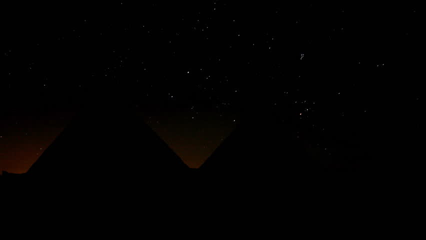 Egyptian pyramids, Giza, during starry night and the upcoming dawn.