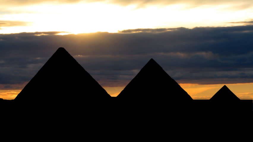 Pyramids in Egypt with cloudy dusk in the background.