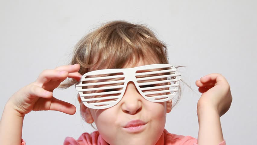 Beautiful girl try on party-style slatted sunglasses
