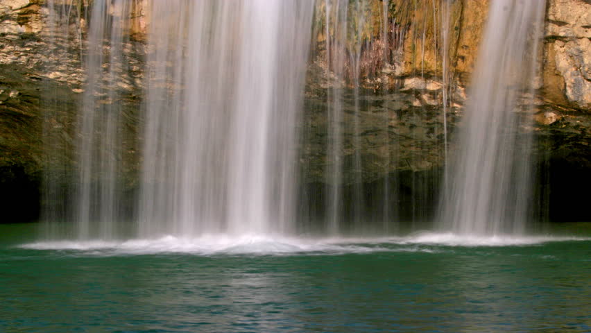 Water falling over a golden rock in Zarecki krov, loopable 