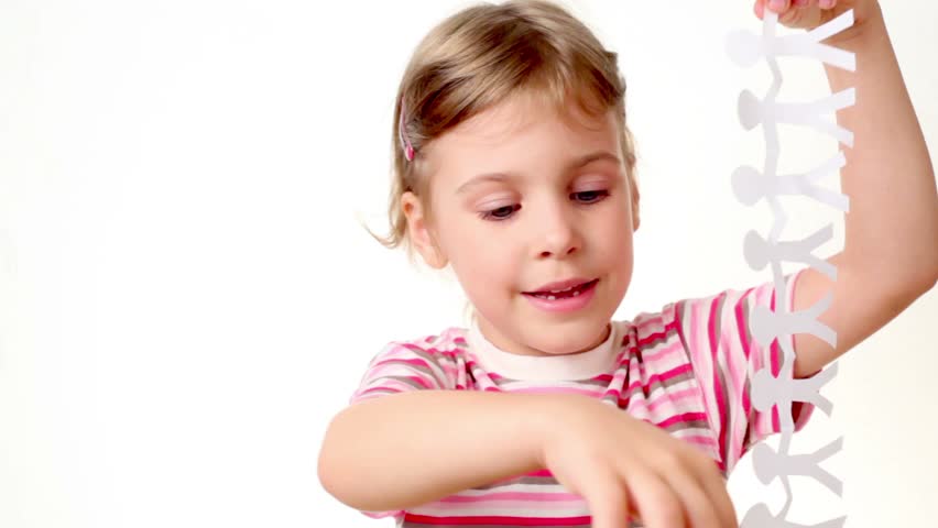 Girl holds two appliques made of paper in form of men, one has texture of dollar