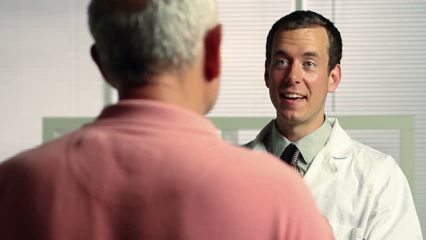 Pharmacist giving prescription to patient