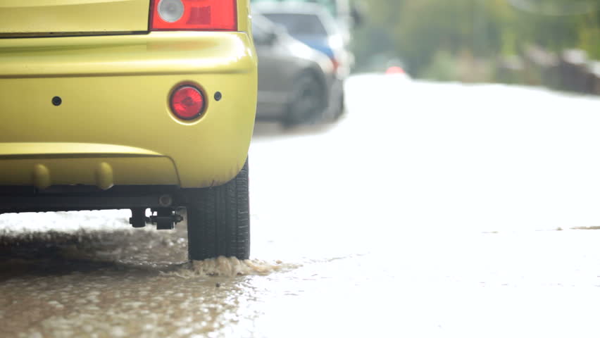 car tire in a stream of of rainwater