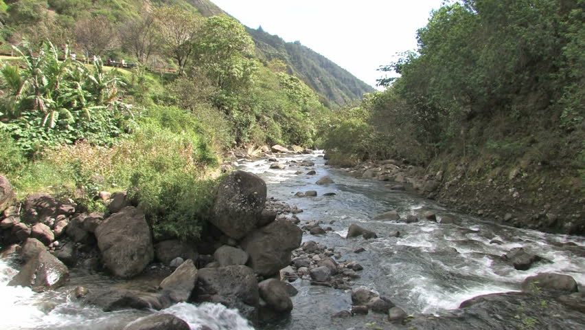 Iao Valley in Maui Hawaii. River in middle of tropical forest. Tourists walking.