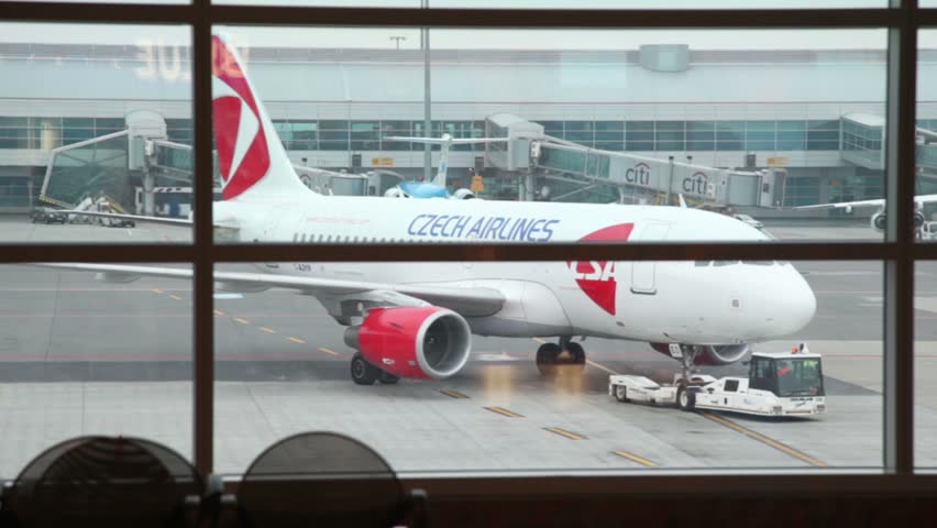 ROME - JULY 6: Tug pulling Czech Airlines plane at airport, July 6, 2010 in Fiumicino airport, Rome. Leonardo da Vinci-Fiumicino Airport, commonly known as Fiumicino Airport, is Italy's largest airport with 36.3 million passengers served in 2010.