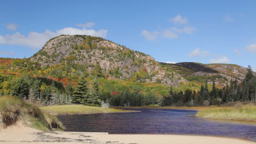 A shadow slowly engulfs The Beehive on a partly cloudy Autumn day in Acadia National Park, Maine.