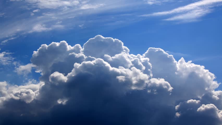 Time lapse clip of white fluffy clouds over blue sky