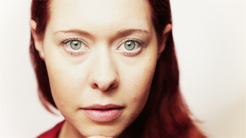 Closeup of a young pensive redhead thinking