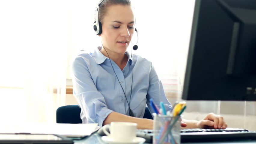Attractive helpdesk consultant talking on headset
