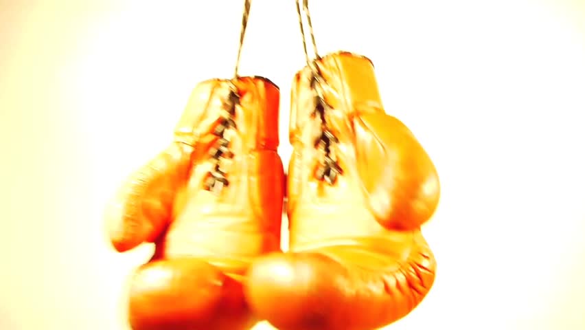 a pair of boxing gloves is hung up and swings - worms eye view make them terrible huge and near