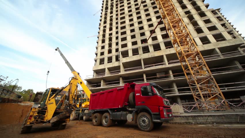 MOSCOW - SEPTEMBER 27: Bulldozer loads truck at building place of living house, September 27, 2010 in Moscow, Russia. Total investment in commercial real estate in Russia in January-June 2011 doubled in yearly terms reaching 1.77bn euros. 