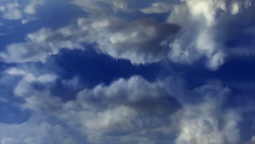 Time lapse clouds evolve and puff in a blue sky.