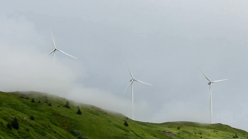 Time Lapse, Wind turbines spin fast through thick fog and clouds creating beautiful, technology scenic. 1080p