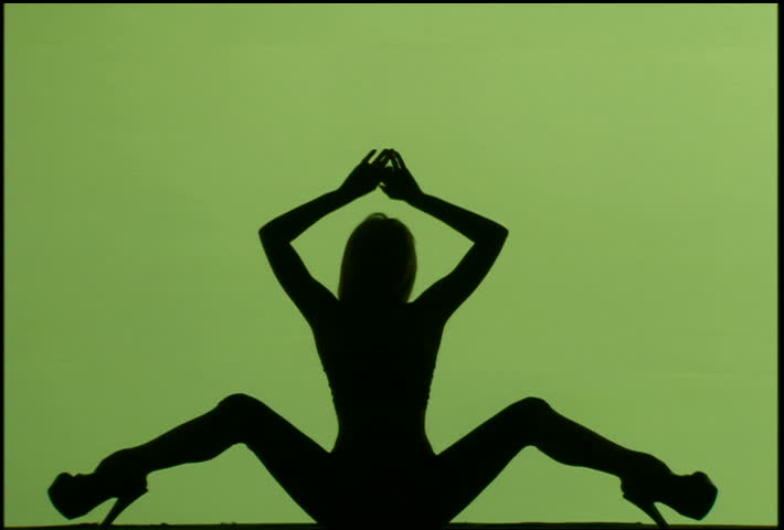 A woman's silhouette dancing against green background
