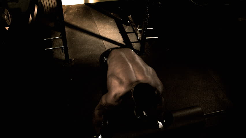 A muscular African male works out. Footage provided in both an extreme color grade and the basic color grade.
