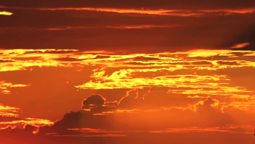 Time Lapse, Sun drops from behind fiery clouds at sunset. 1080p 