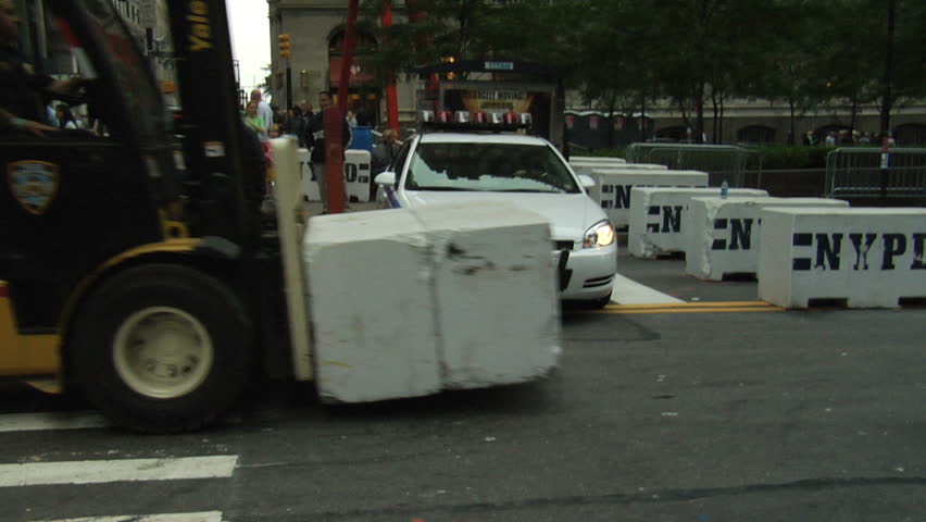 NEW YORK - SEPT 11: Police move cement barriers on Broadway in the frozen zone near to the World Trade Center site on the 10th anniversary of the terror attacks on September 11, 2011 in New York. 