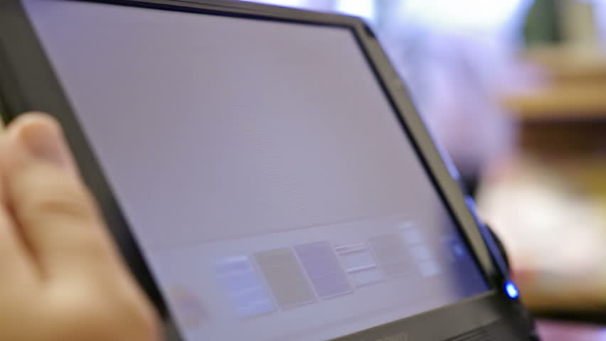 closeup of finger touching screen with monthly budget on tablet-pc with shallow depth of field