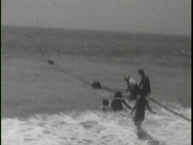 CALIFORNIA - CIRCA 1930: People mill around 1930's cars and an old biplane in this old home movie.
