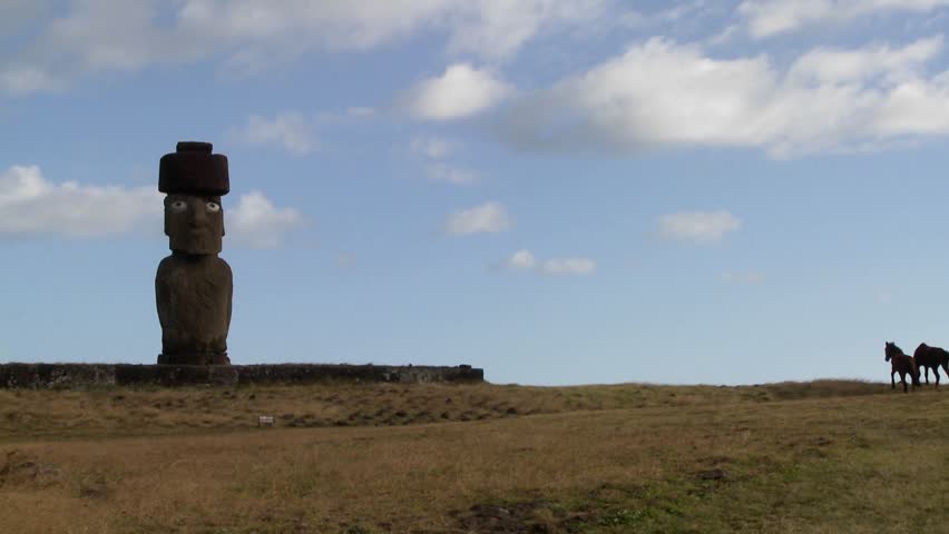 Horses wander near one of Easter Island's amazing statues.