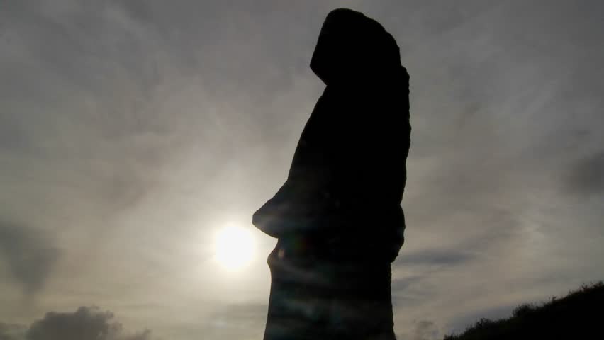 Clouds move behind Easter Island statues.