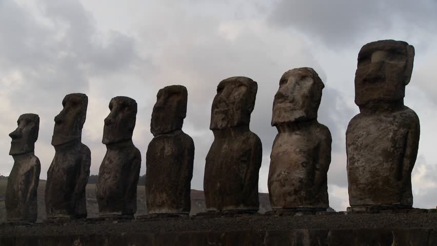 A long line of statues is silhouetted on Easter Island in this time lapse shot.