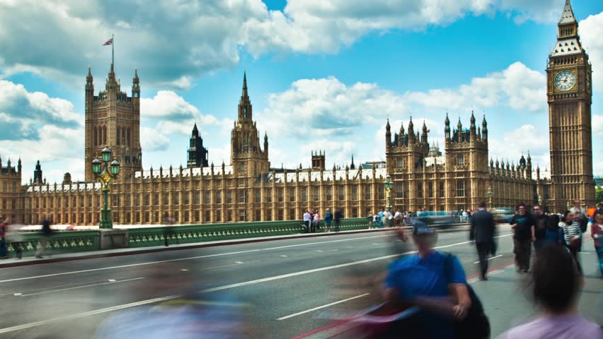 WESTMINSTER, LONDON - CIRCA JULY 2011: (Timelapse View) Big Ben on Westminster Bridge as traffic and people zip by and clouds roll in circa July 2011 in London.
