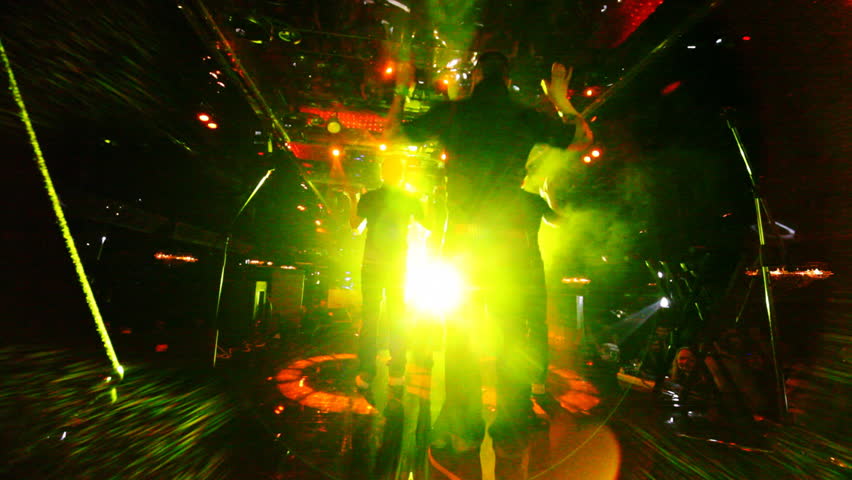 group of young guys dancing hip-hop in nightclub, view from behind scenes