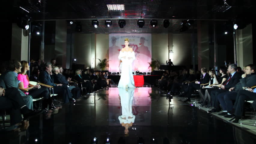 MOSCOW - FEBRUARY 14: Model in long white wedding dress with fur cape on her shoulders walks catwalk at Evening of French fashion in salon Estet, on February 14, 2011 in Moscow, Russia.