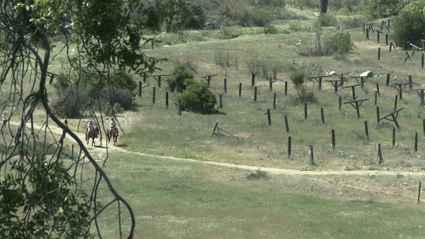 Two hikers and horse riders on a trail on the Ventura River Preserve in Ojai, California.