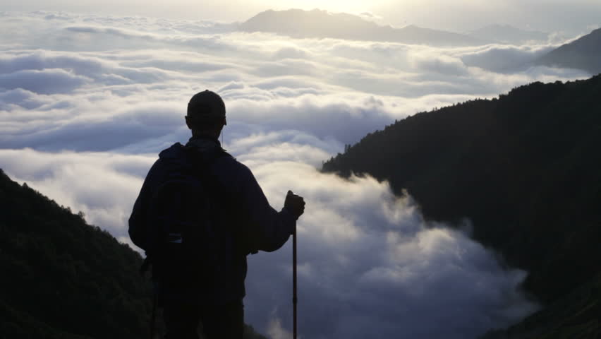 The traveler, mountains and clouds